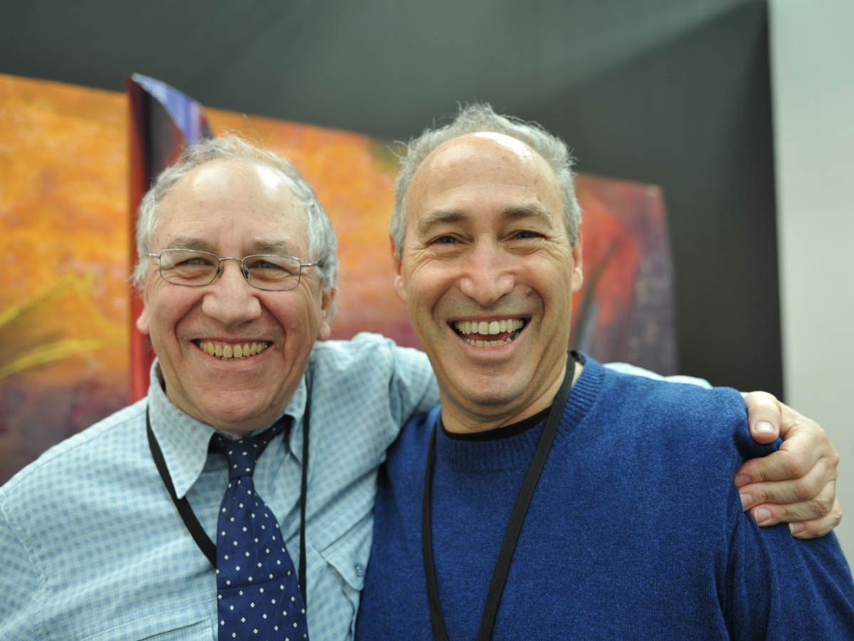 Two men smiling for a picture together.