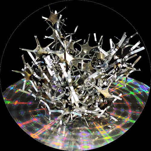 A metal sculpture of stars on top of a disc.