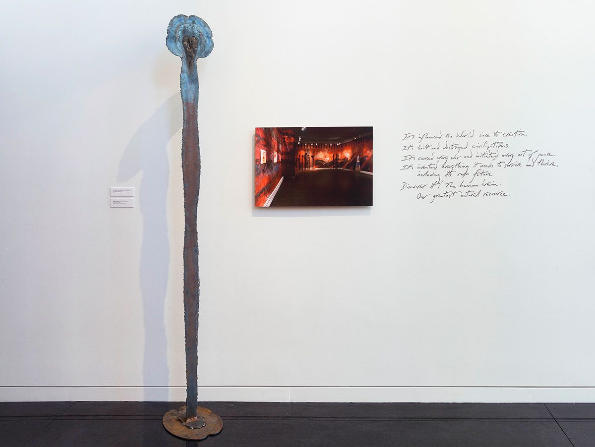 A wooden pole and a painting on the wall